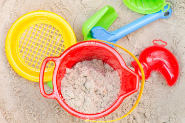 plastic toys in sandpit
