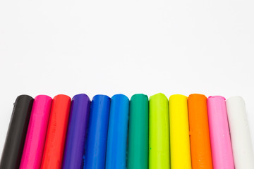 Art rainbow colours clay sticks on white background