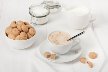 Amaretti Biscuits. Cup Of Cappuccino Coffee. Lump Demerara Sugar