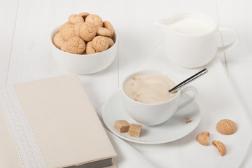 Amaretti Biscuits. Cup Of Cappuccino Coffee. Lump Demerara Sugar