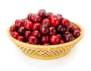 Sweet cherry berries (Prunus avium) in wicker plate