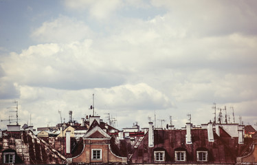 Old roofs and sky with clouds - obrazy, fototapety, plakaty