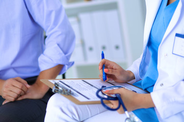 Woman doctor talking to her male patient at office