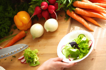 Young woman cutting vegetables in the kitchen