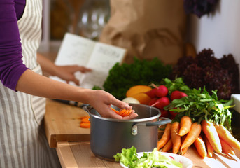 Young woman cutting vegetables in the kitchen