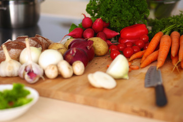 Young woman cutting vegetables in the kitchen