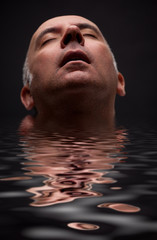 Close up of a man's head in the water