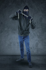 Frightening murderer carrying a chain