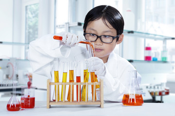 Little scientist making experiment in the lab