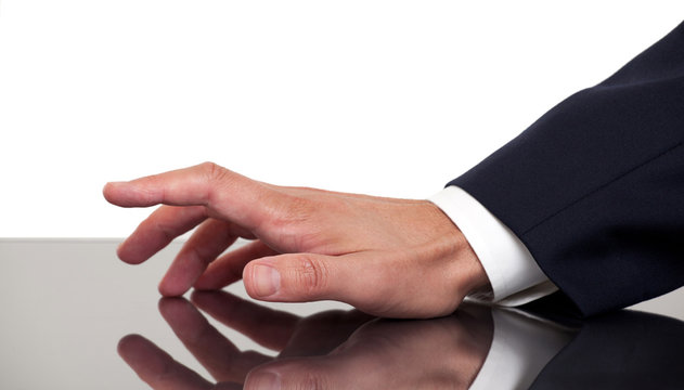 Business man's hand tapping fingers on a desk