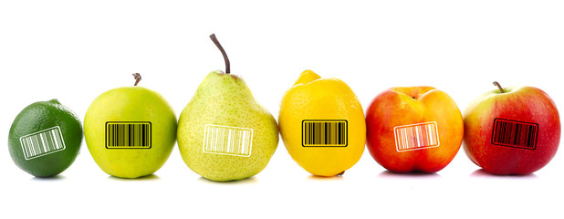 Assortment of juicy fruits with barcodes isolated on white