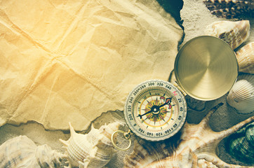 compass on burn paper and sand backgroud