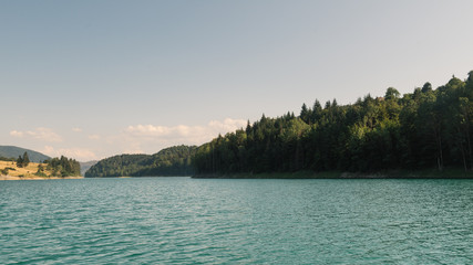  Clear mountain lake and rocky mountains in late summer.