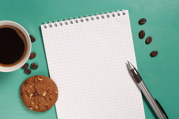 Coffee with cookie and notepad