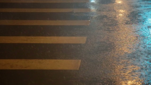 Heavy rain on pedestrian crossing and street slow motion
