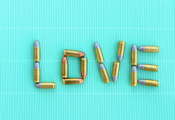  love letters by 9 mm bullets on green vintage background