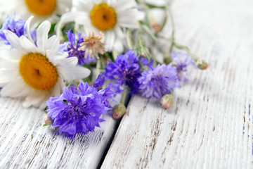 Fresh wildflowers on wooden table, closeup