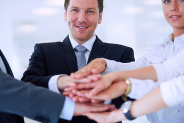 Fototapeta premium Business people with their hands together in a circle
