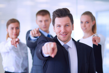 Group of business people pointing to you 