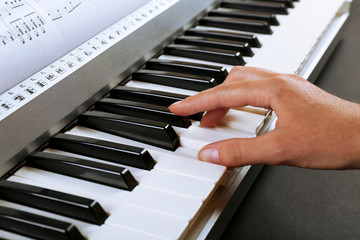 Fototapeta premium Woman playing synthesizer close up
