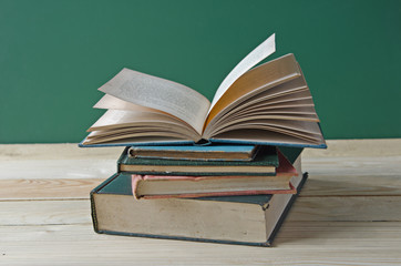 A pile of books on wooden table