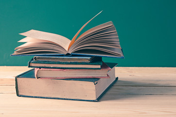 A pile of books on wooden table