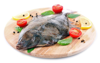 Fresh fish with spices on cutting board isolated on white