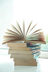 Books on white windowsill, close up
