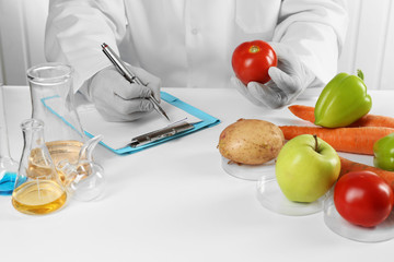 Scientist examines vegetables in laboratory