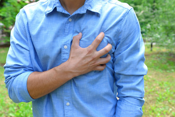 Man having chest pain - heart attack, outdoors