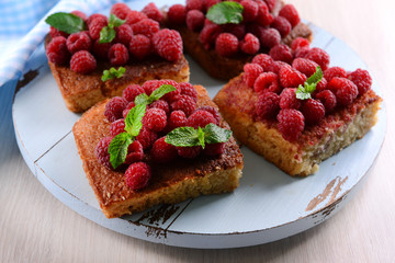 Fresh pie with raspberry on wooden tray, closeup