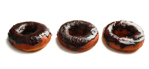 Delicious doughnuts with chocolate icing isolated on white