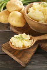 Mashed potatoes in bowl on wooden table, closeup