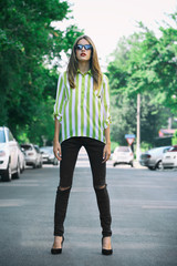 Fototapeta premium Beautiful young girl posing on city street