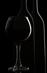 Naklejka na ściany i meble Bottle and glass of wine isolated on black