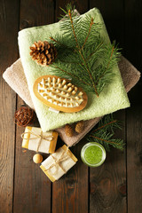 Handmade soap and cream with pine extract and spa treatments on wooden background