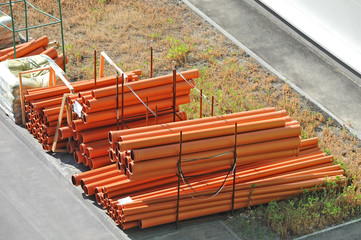 Stacked new PVC pipe on construction site