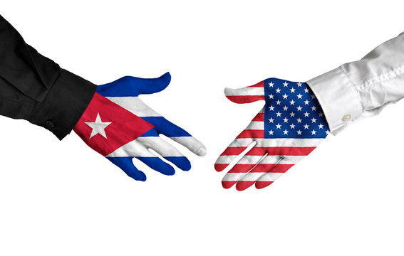 Cuban and American leaders shaking hands on a deal agreement