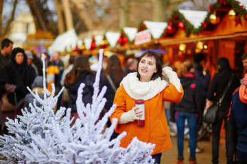 Fototapeta premium Happy young girl on a Parisian Christmas market