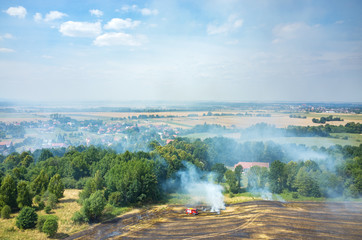 Fireman truck working on the field on fire