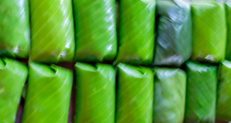 blur Glutinous rice steamed in banana leaf (thai dessert)