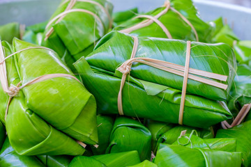 blur Glutinous rice steamed in banana leaf (thai dessert)