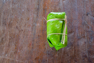 Glutinous rice steamed in banana leaf on a  table (thai dessert)