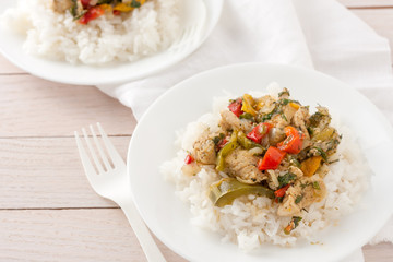 chicken or pork with peppers and herbs and spices over rice