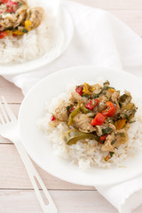 chicken or pork with peppers and herbs and spices over rice