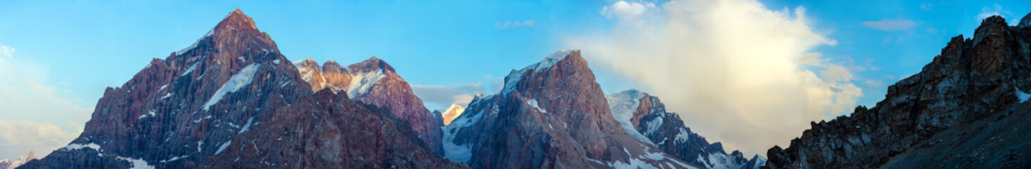 Evening panorama of Fan Mountains range.
Large and super wide panoramic image of high peaks in sunset light