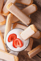 Savoiardi and mascarpone with strawberries closeup. vertical top view 
