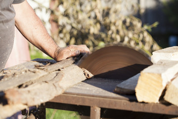 Fototapeta na wymiar Lumberman working on circular saw