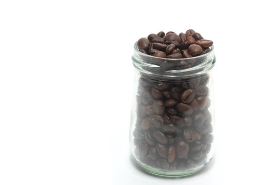 Coffee beans in a cristal jar on a white background