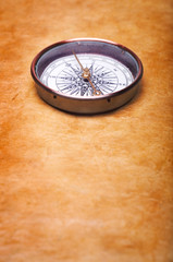 Fototapeta na wymiar compass on vintage paper background